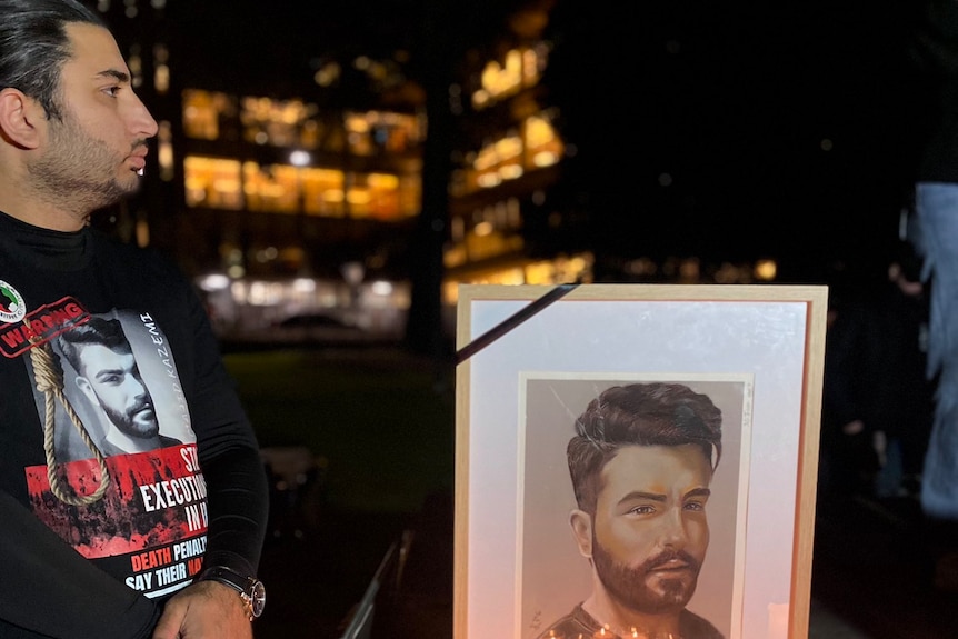 a vigil with candles and the photo of the man executed by Iran's regime