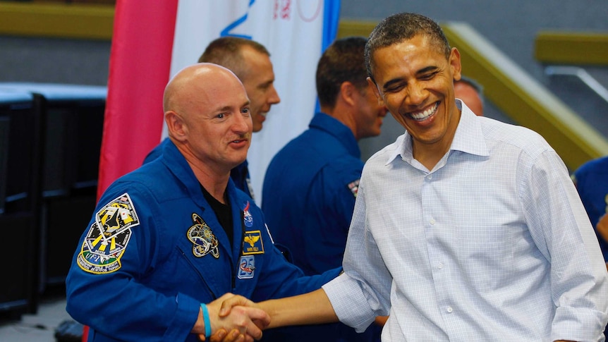 US President Barack Obama shakes hands with space shuttle Endeavour mission commander Mark Kelly