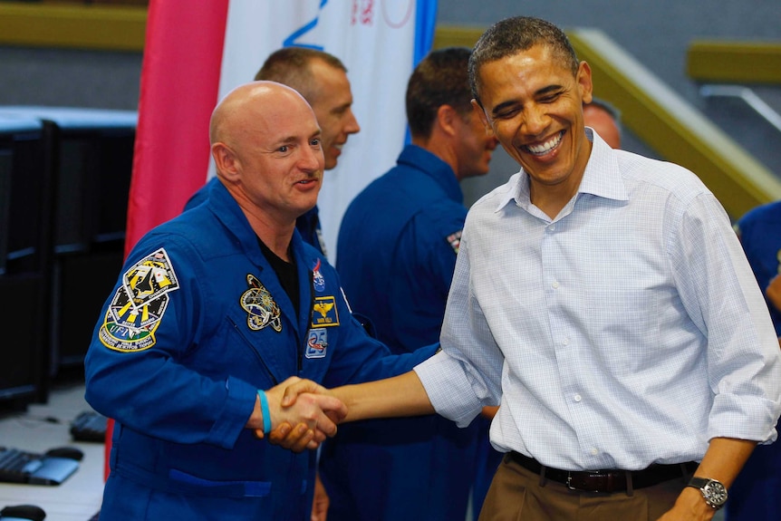 US President Barack Obama shakes hands with space shuttle Endeavour mission commander Mark Kelly
