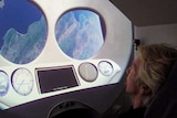 Richard Branson in the cockpit of a spaceship.