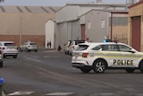 Police cars outside warehouses