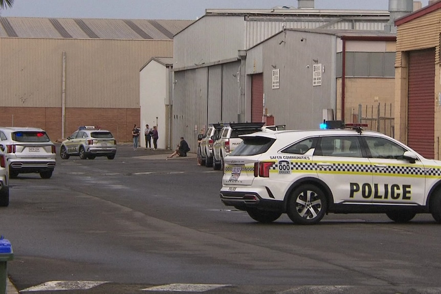 Police cars outside warehouses