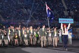 Australia marches behind a woman who is holding up a banner saying Australia