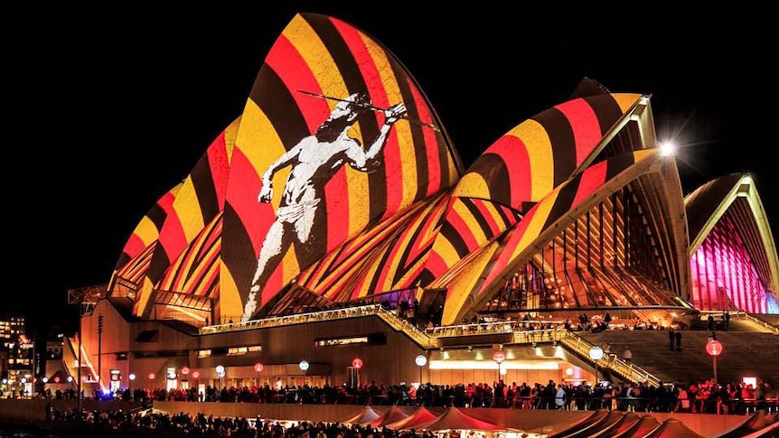 An Indigenous design is projected onto the side of the Sydney Opera House at night.