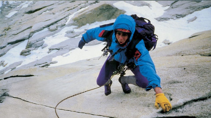 Paul Pritchard climbing up an icy rock wall.