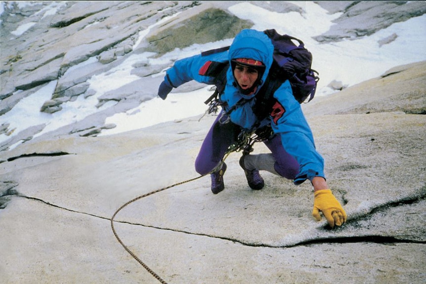 Paul Pritchard climbing up an icy rock wall.