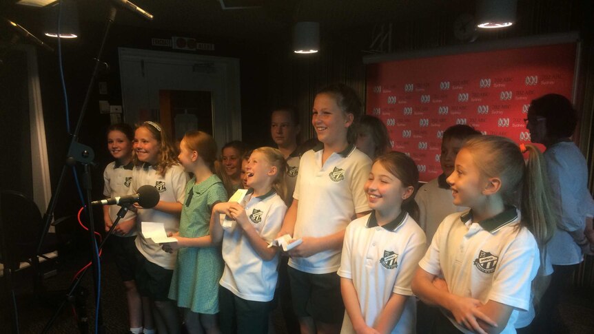 Jannali Public School choir perform their national anthem in the 702 ABC Sydney studio
