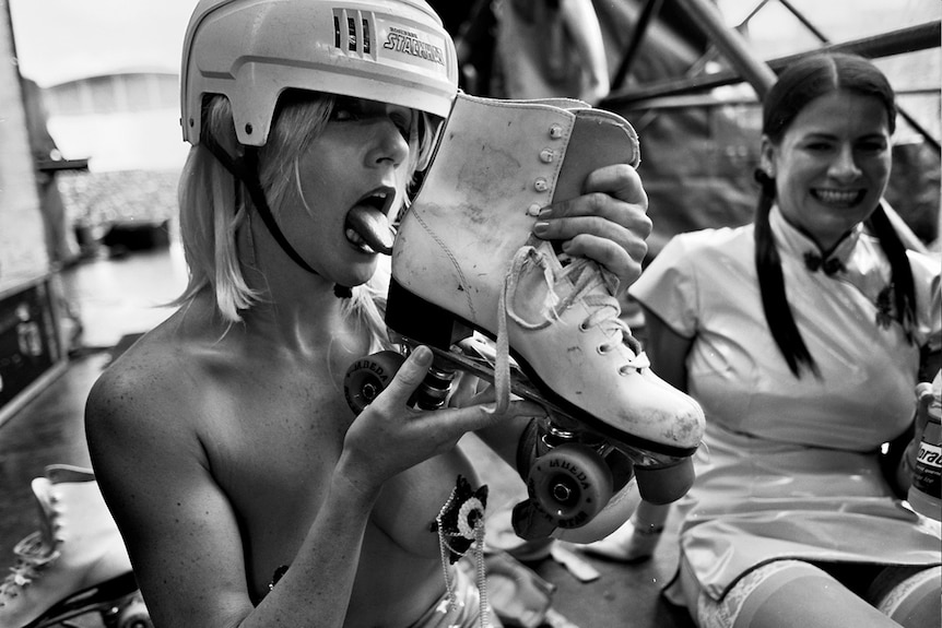 Christa Hughes licking a rollerskate