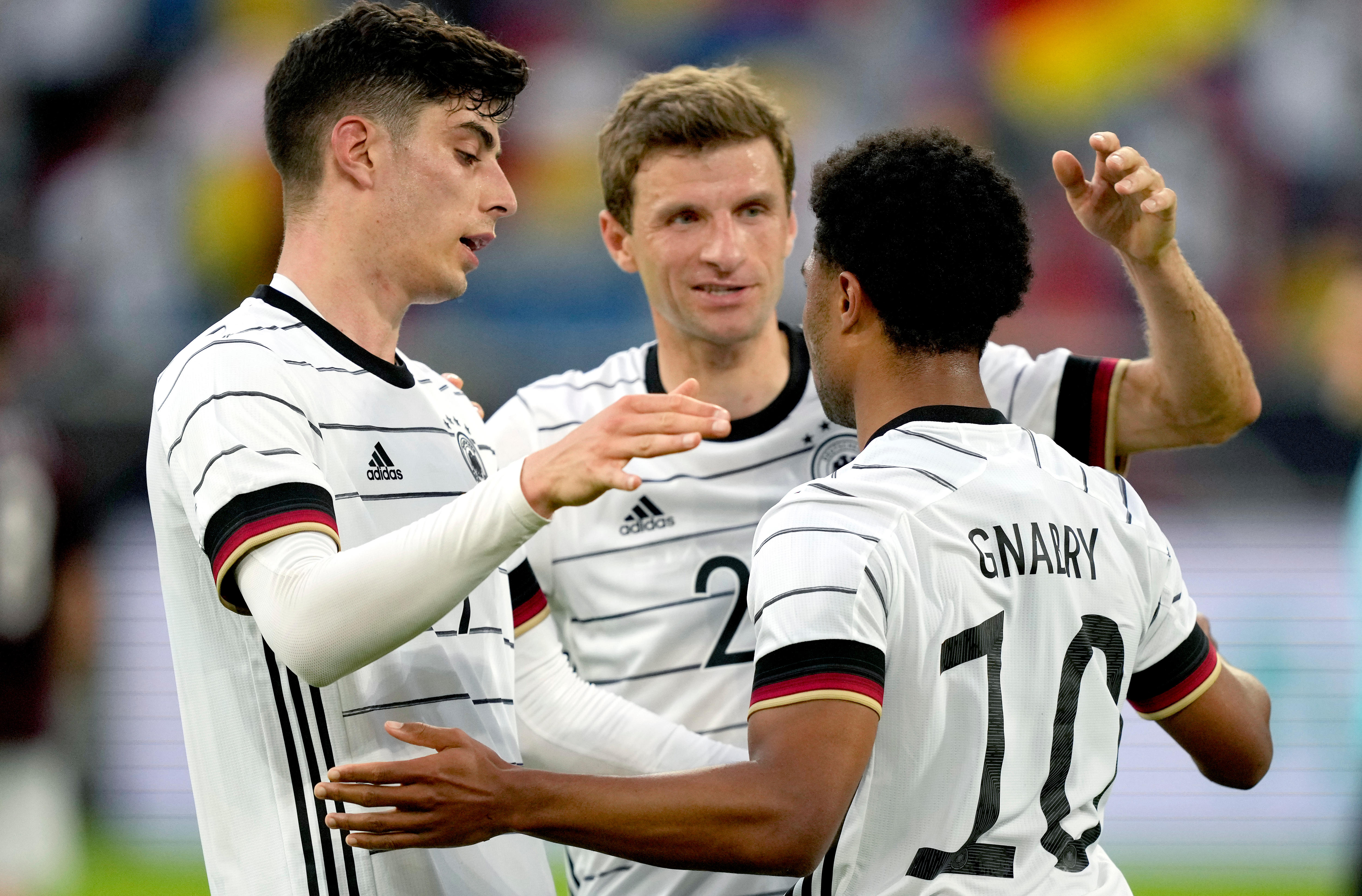 Serge Gnabry, Kai Havertz and Thomas Mueller hug