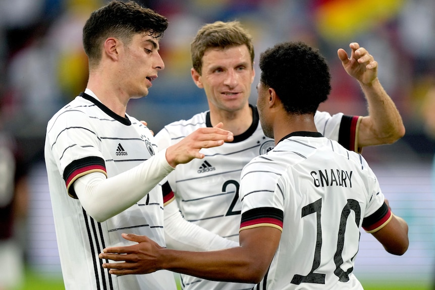 Serge Gnabry, Kai Havertz and Thomas Mueller hug