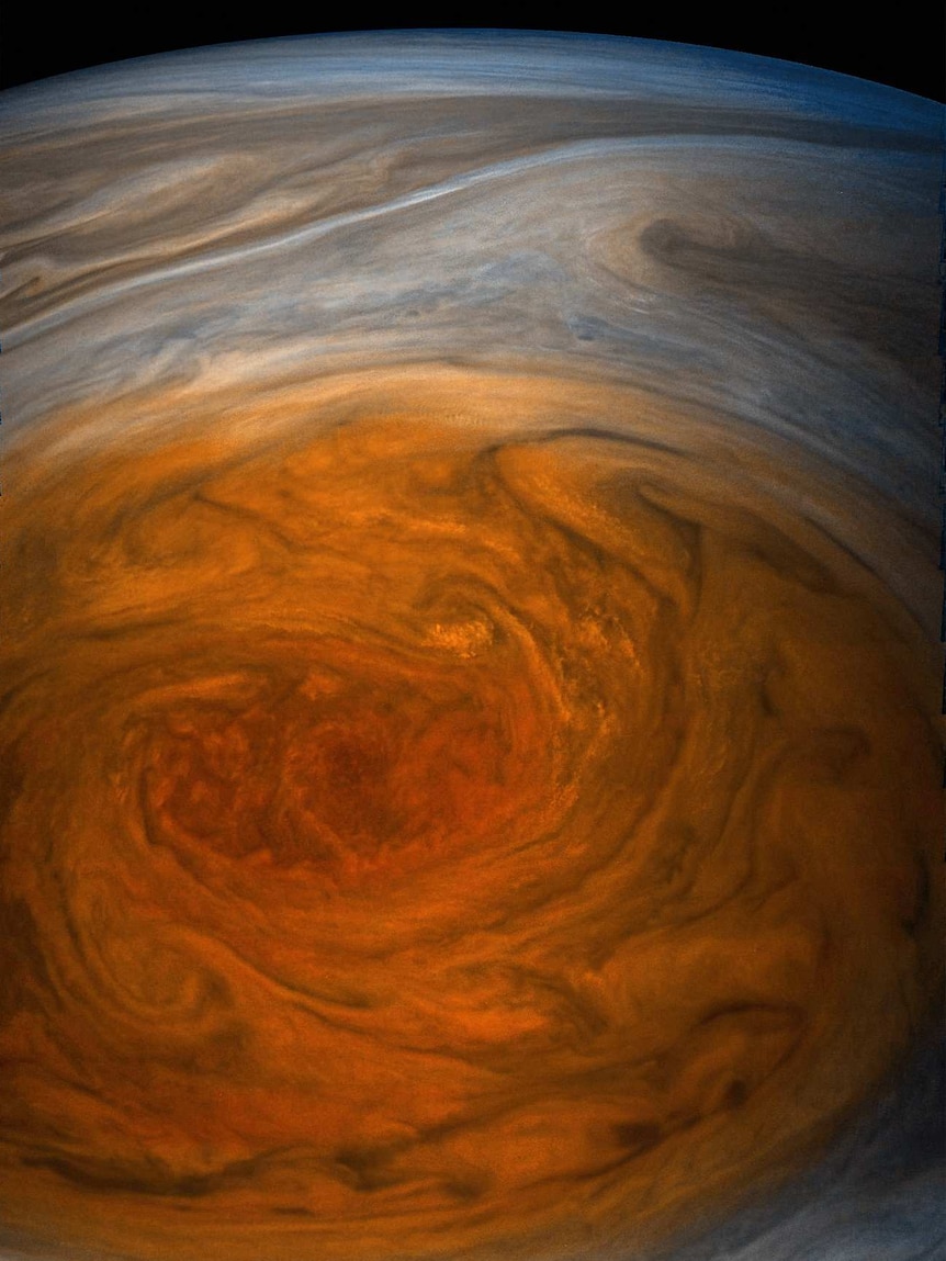 A close-up image of Jupiter's Great Red Spot shows roiling orange clouds.
