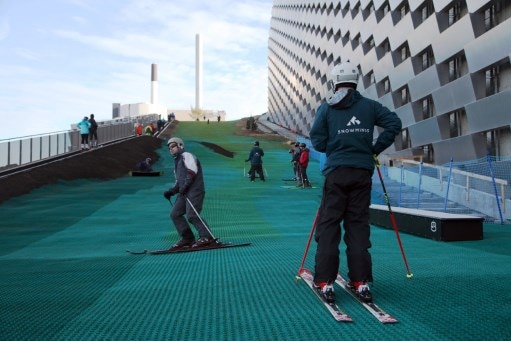 Skiers are seen making their way down the green slope.