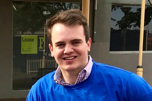 Marcus Bastiaan wears a blue t-shirt over a checked shirt.