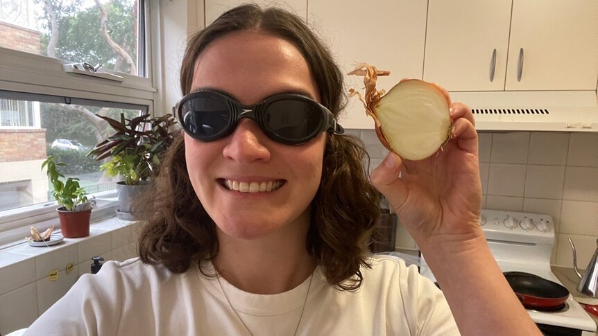 Journalist Rachel Rasker wearing very fashionable swim goggles and holding an onion.