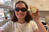 Journalist Rachel Rasker wearing very fashionable swim goggles and holding an onion.
