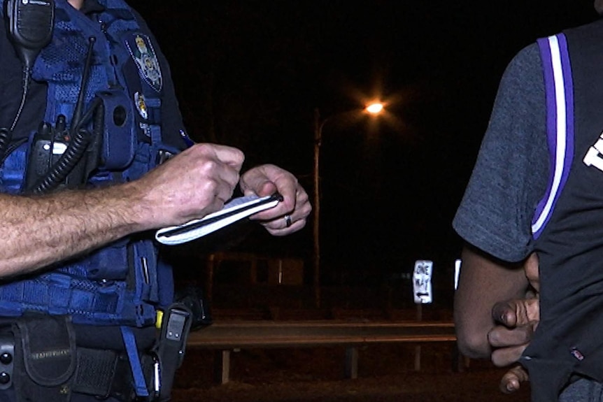 Senior Sergeant Brad Inskip records the details of a 16-year-old boy