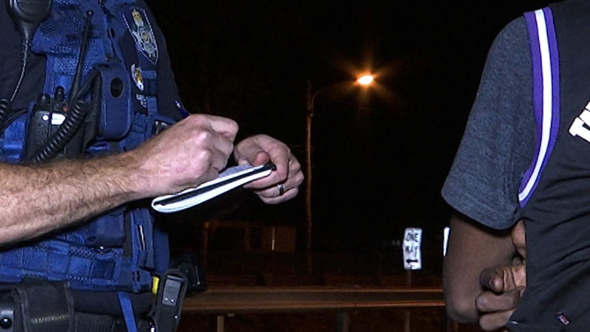 Senior Sergeant Brad Inskip records the details of a 16-year-old boy