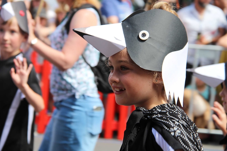 Child dressed in bird costume.