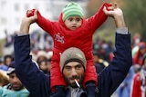 Asylum seekers march towards Austrian border