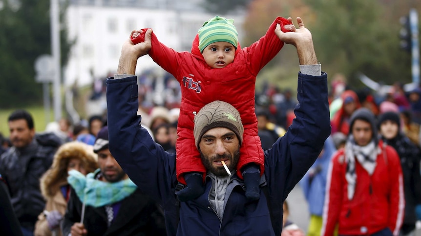 Asylum seekers march towards Austrian border
