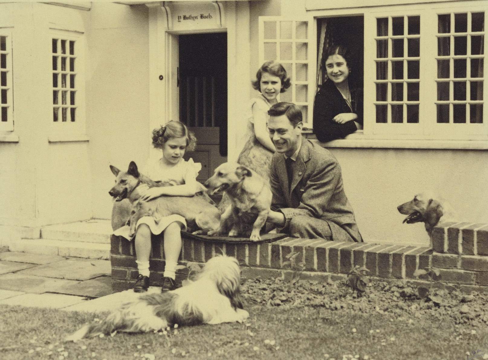 King George VI and Queen Elizabeth with Princesses Elizabeth and Margaret and some canine companions including Dookie and Jane.