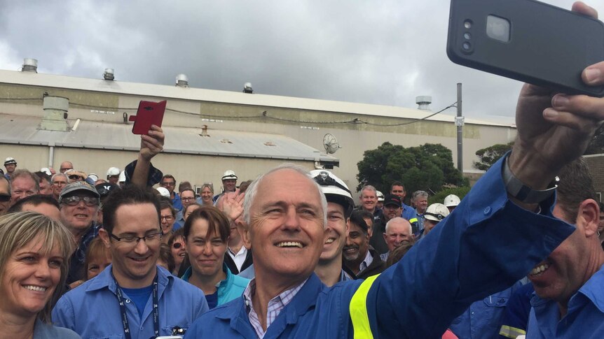 Prime Minister Malcolm Turnbull takes a selfie with Alcoa workers