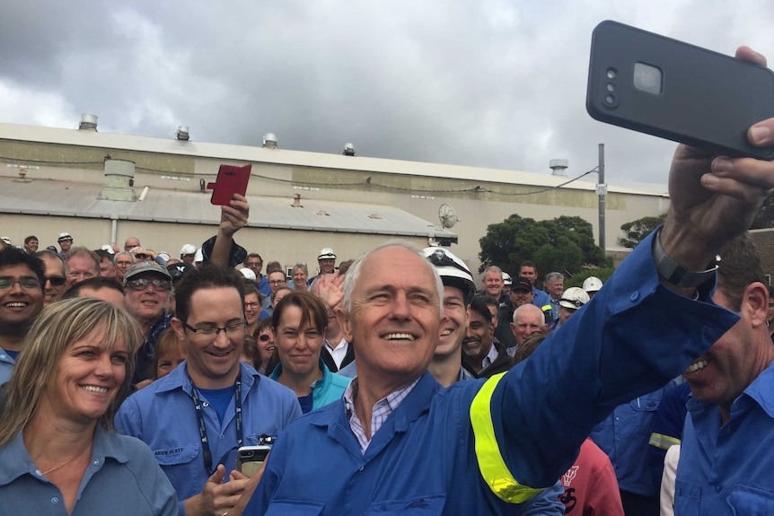 Prime Minister Malcolm Turnbull takes a selfie with Alcoa workers