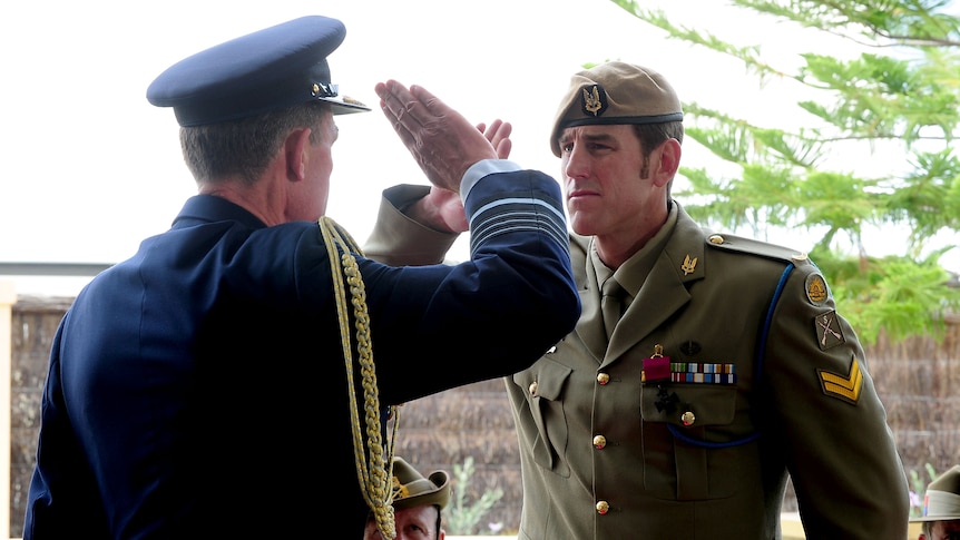 Air Chief Marshal Angus Houston salutes Australian Army soldier Corporal Ben Roberts-Smith during Victoria Cross ceremony.