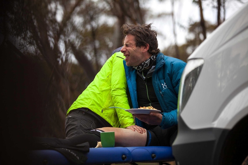 Mark Beaumont winces as his physio massages his legs.