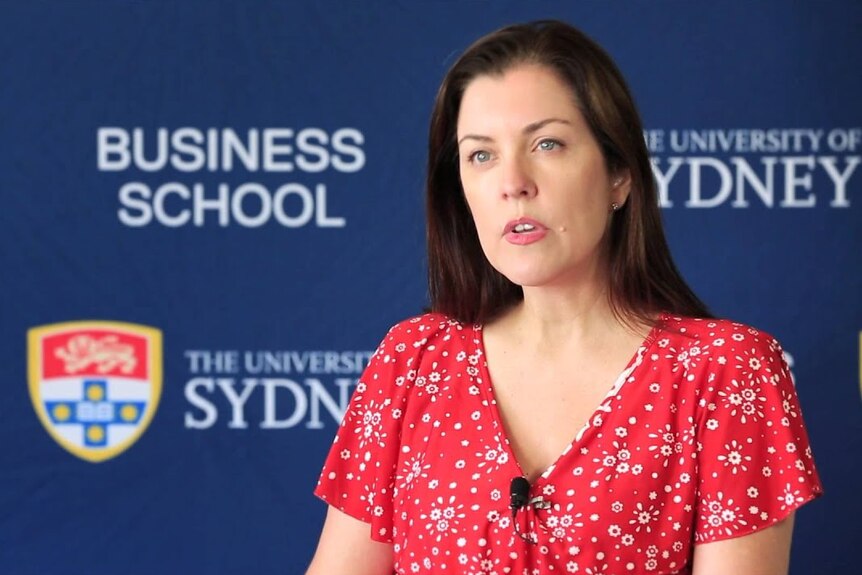 Associate Professor Juliette Overland with a University of Sydney Business School backdrop behind.