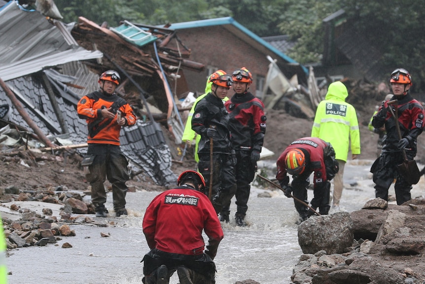 Rescuers at the scene of a landslide in South Korea. 