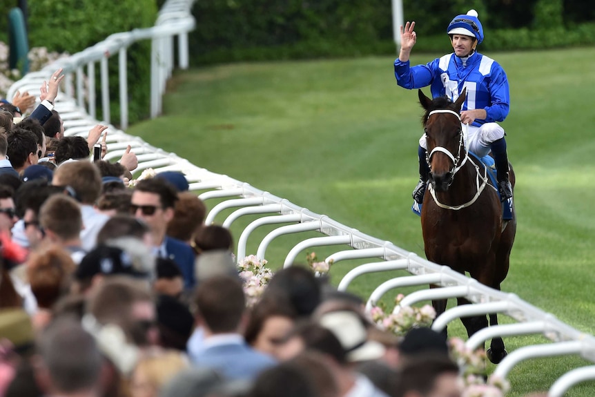 Hugh Bowman reacts after riding Winx to victory in the Cox Plate at Moonee Valley in 2015.