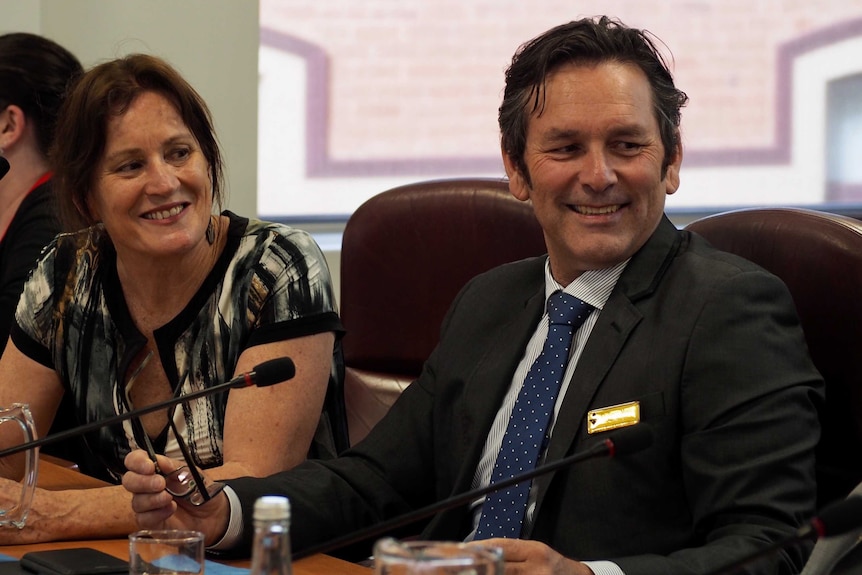 Mildura Rural City Councillor Jason Modica smiles as he looks off camera during a meeting.