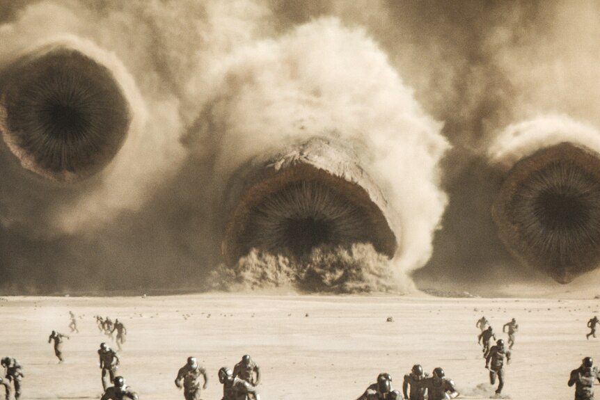A film still of three giant swirling dusty vortexes/holes in the desert, with people fleeing