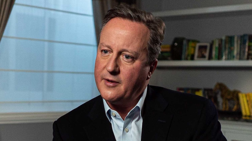 David Cameron wears a blue shirt and black jacket.