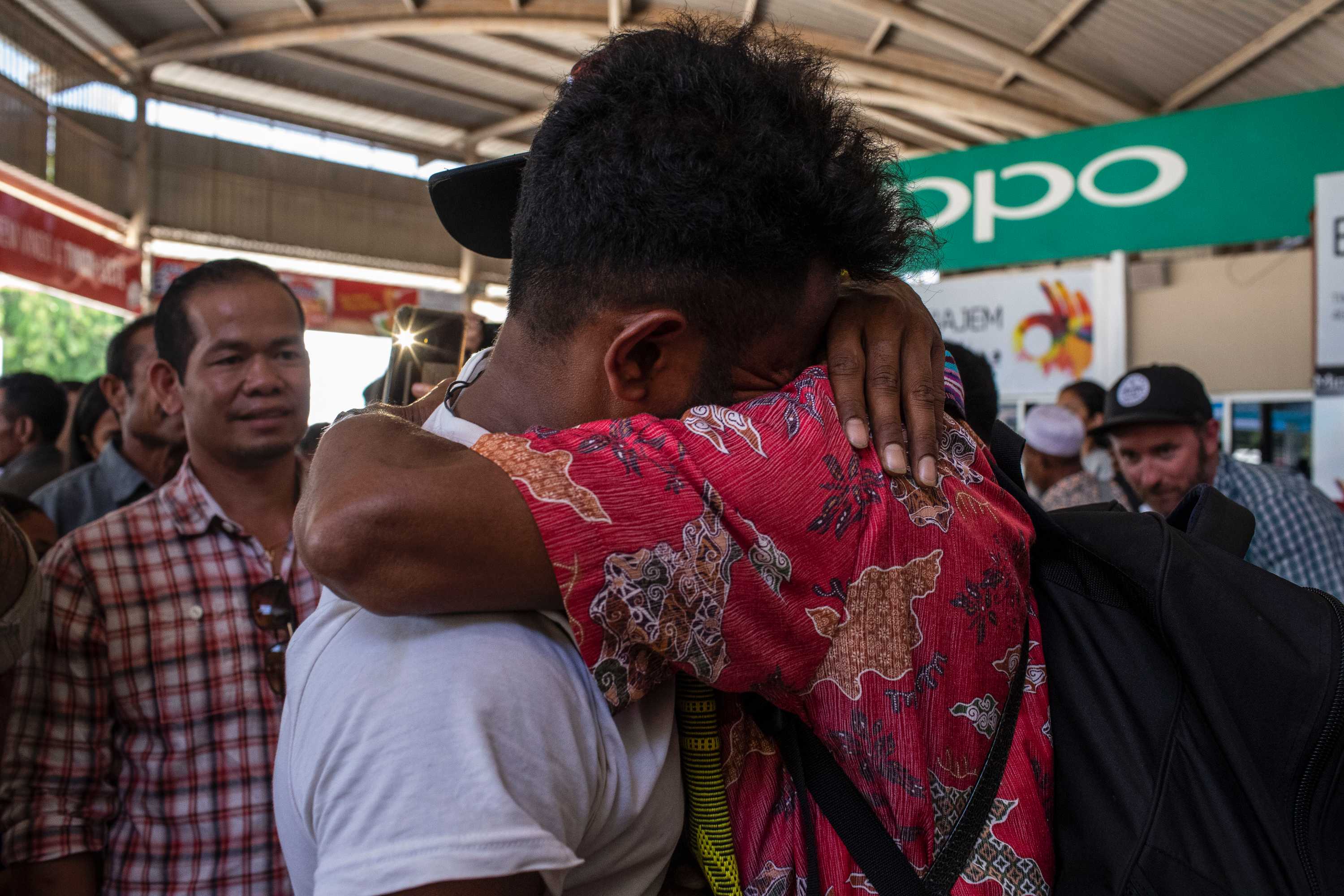 A man hugs a relative.