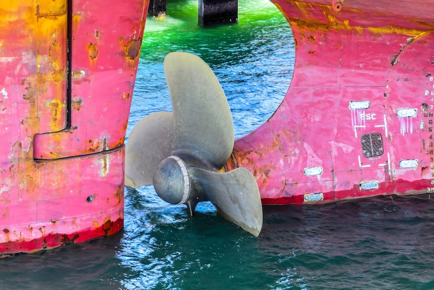 A photo of a propeller on a ship in the water