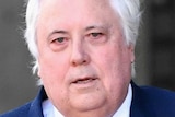 Clive Palmer walks outside of the Brisbane Supreme Court.