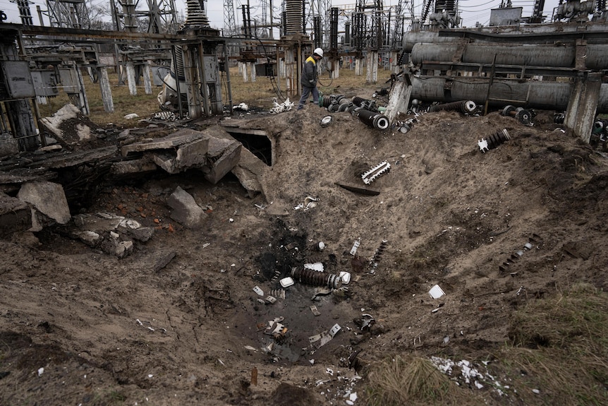 a crater dirt inside a Ukrainian power plant caused by a Russian attack with debris to the side