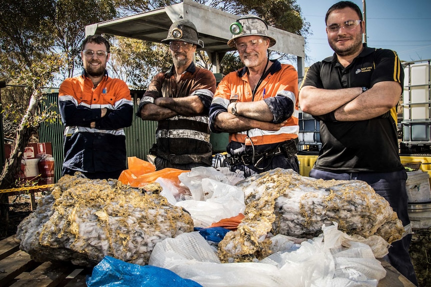 Mine workers posing with rare gold specimens