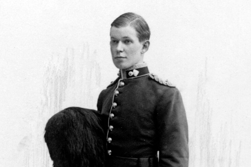 A black and white photograph of a young man wearing formal army attire.