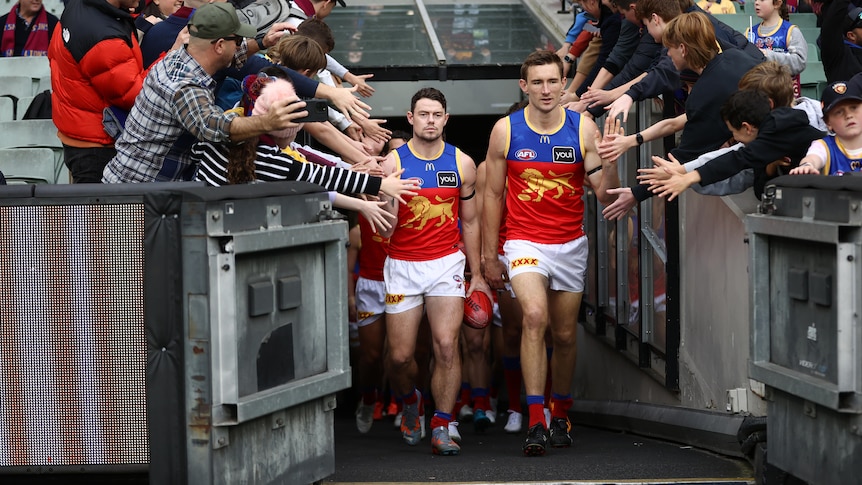 Brisbane Lions players walk out at the MCG