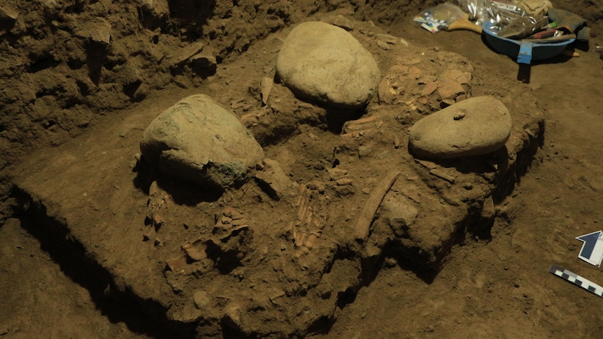 Bones and rocks at the bottom of a pit