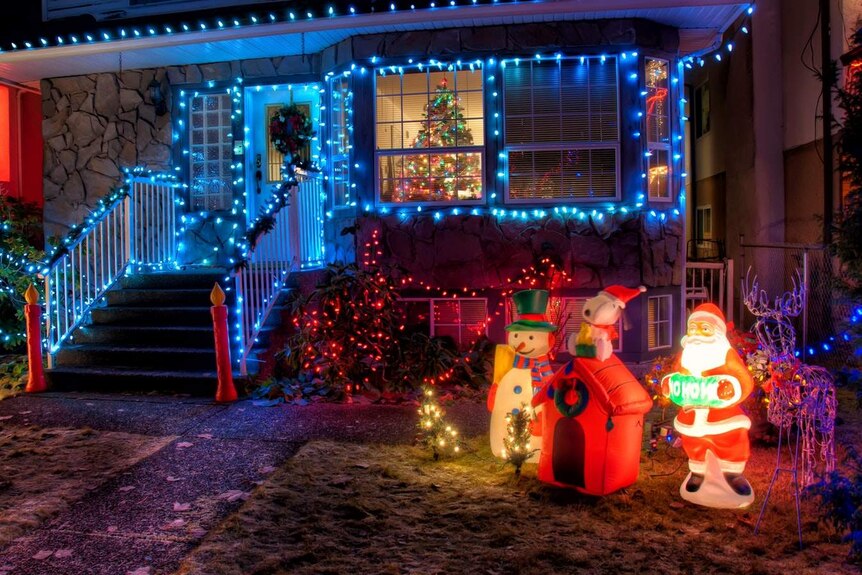 A suburban house decorated with Christmas lights.