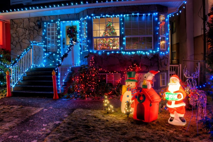A suburban house decorated with Christmas lights.