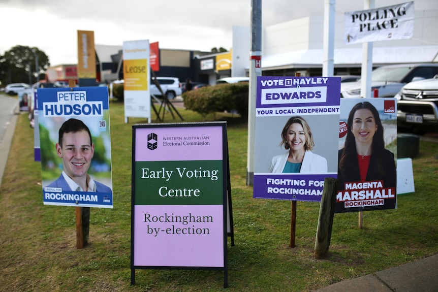 Placards for candidates posted on lawn outside an Early Voting Centre for the Rockingham by-election.