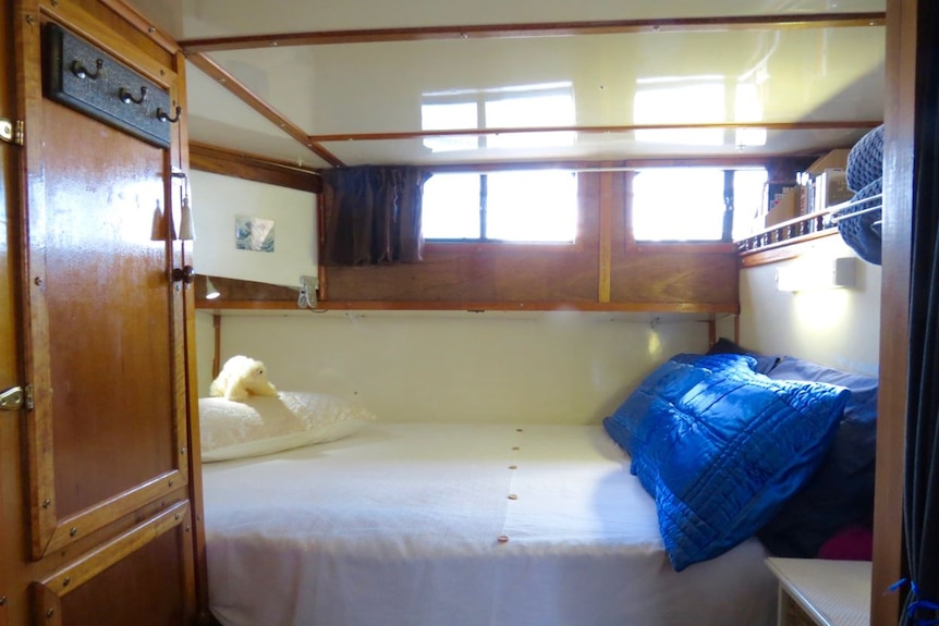 The interior of a bedroom cabin on a boat