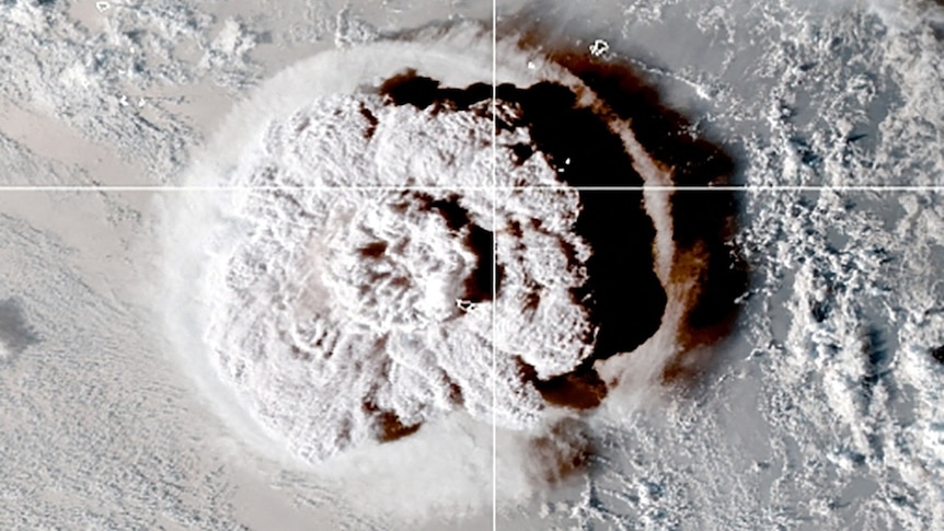 A satellite image shows an enormous cloud of volcanic dust spreading across a vast ocean.