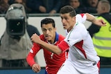Voria Ghafouri challenges for a ball with Chile's Alexis Alejandro Sanchez.