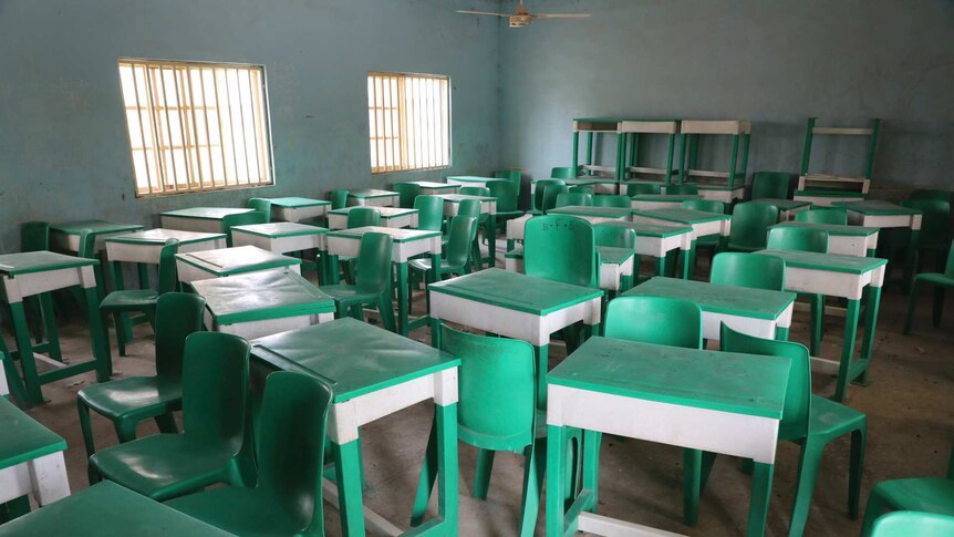 Lime green desks sit in an empty classroom after the attack